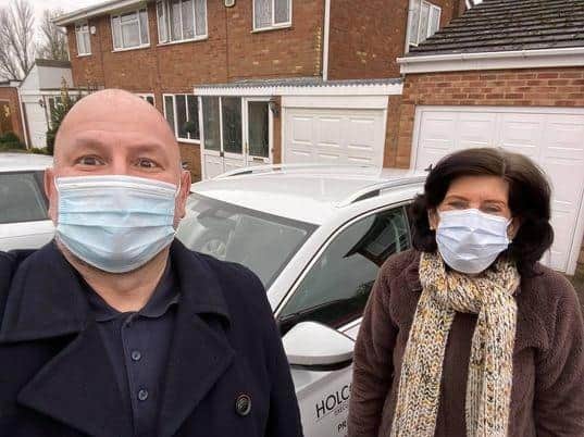 Nick Metaxas of Holcot Cars with his first customer for the free taxi ride to a coronavirus vaccination appointment