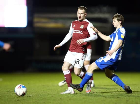 Bryn Morris gets a pass away during the Cobblers' 1-0 defeat to Wigan Athletic on Tuesday night (Pictures: Pete Norton)