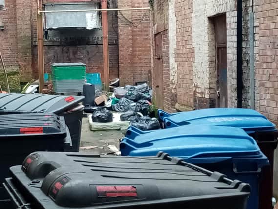 The Chronicle & Echo is calling on the owners of a heavily flytipped alleyway in Northampton town centre to clean their property.