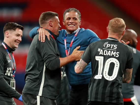 Keith Curle celebrates the Cobblers' play-off final success at Wembley with assistant boss Colin West and club captain Nicky Adams