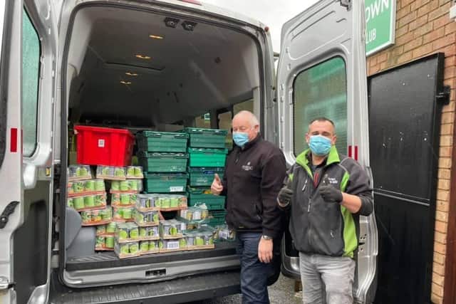 TowFood volunteers unpack up a van full of surplus food