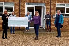 Persimmon Homes Midlands sales director Claire Dearsley (second left) presents Community Champions funding to Brenda Woolf and volunteers from Roade Community Larder