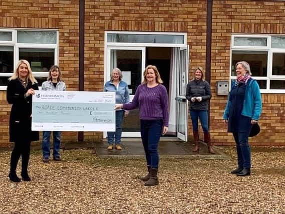 Persimmon Homes Midlands sales director Claire Dearsley (second left) presents Community Champions funding to Brenda Woolf and volunteers from Roade Community Larder