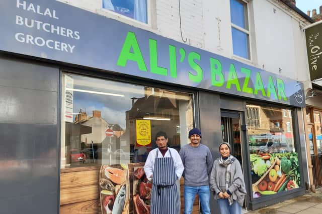 Mansur Rahman (middle) and Shanaz Parbin (right) with the family butcher on the left
