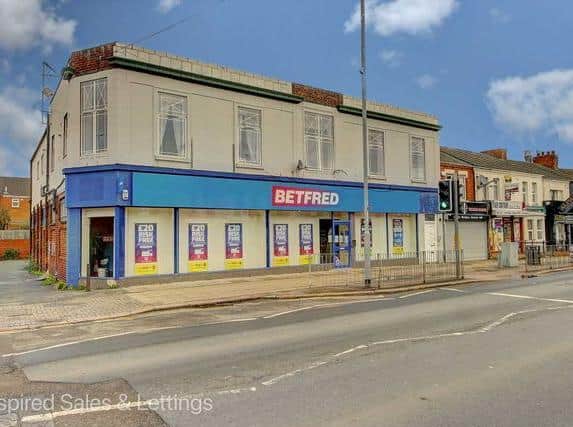 The flat is above a bookies in St Leonard's Road, Far Cotton
