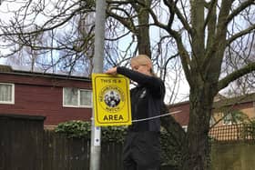 Northampton Borough Council Neighbourhood Warden installing the signs