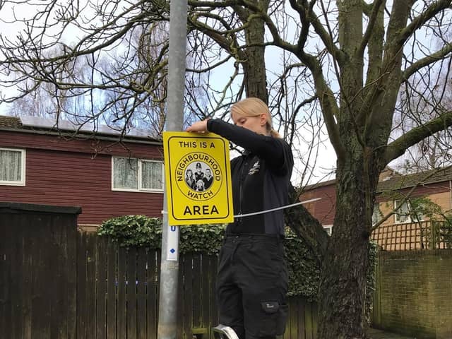 Northampton Borough Council Neighbourhood Warden installing the signs