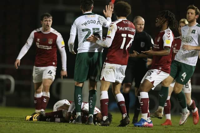 Plymouth's Sam Woods is shown a late red card for his foul on Ricky Korboa