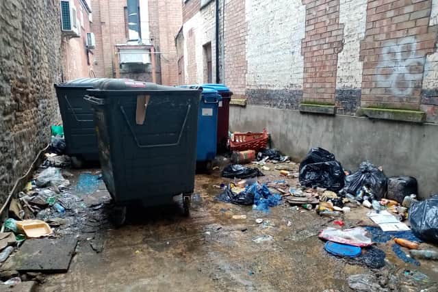 A picture of the alleyway in February taken by the Chron. Weeks and weeks of flytipping and littering had built up.