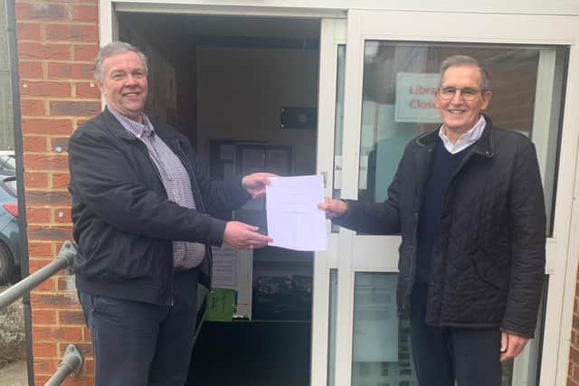 Councillor Murray, chairman of the parish council (left) handing the lease over to Roger Wood, chair of Roade Junction Community Group (right).
