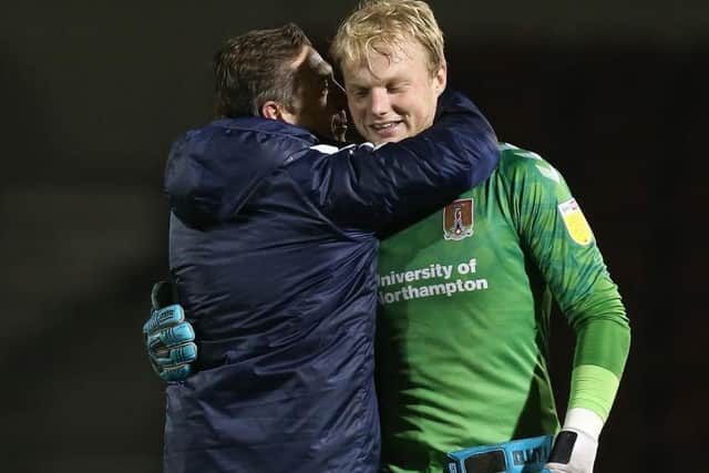 Jon Brady and goalkeeper Jonathan Mitchell embrace after Tuesday's victory. Picture: Pete Norton