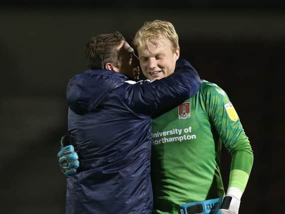 Jon Brady and goalkeeper Jonathan Mitchell embrace after Tuesday's victory. Picture: Pete Norton