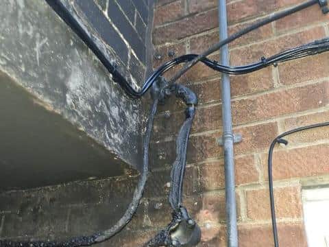 The tenant is concerned about the electrical wires that have melted and are now exposed.