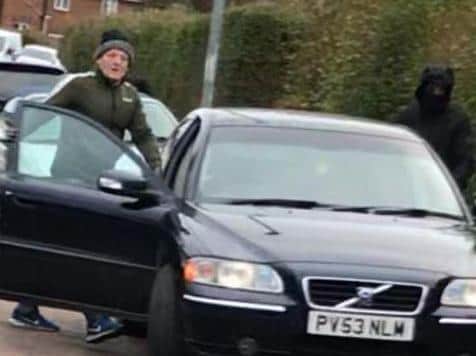 Two of the three men pictured before they sped off.