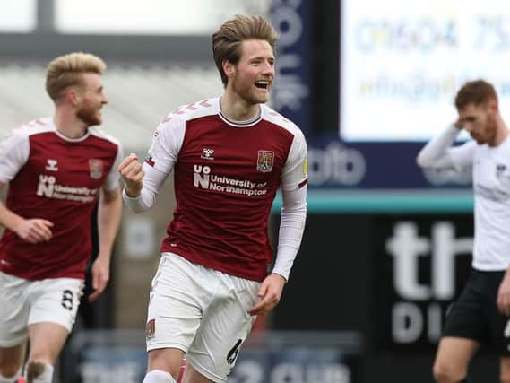 Fraser Horsfall wheels away in delight after scoring his second Cobblers goal.