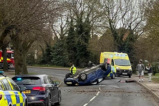 A unattended electric scooter lies in the road after the crash