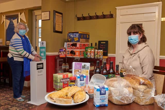 Tiffield resident Phyllis Power (left) drops in to pick up some essentials from The George, with publican Laura Cook