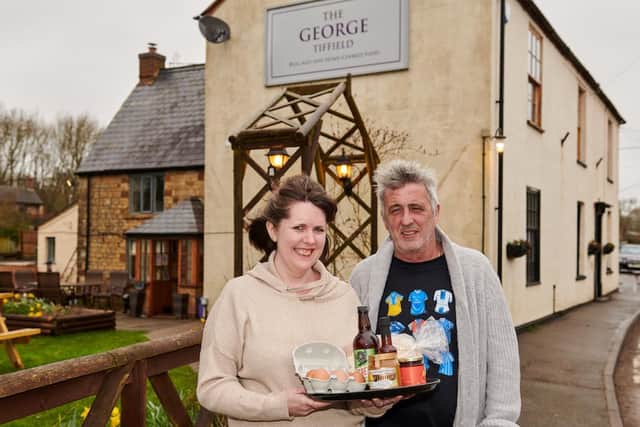 Laura Cook and Martin Steele, landlords of The George in Tiffield, celebrate the opening of their shop