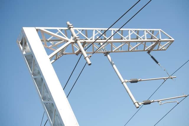 Cables above train tracks carry up to 25,000 volts