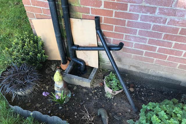 The broken guttering has fallen into Patricia's small garden.