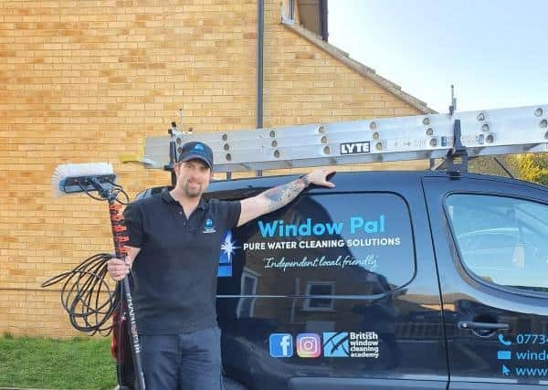 Robert Vaughan is using his business Window Pal to lean up road signs to give back to the community.
