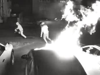 Two yobs are caught on camera torching three cars on a drive in Weedon in the early hours of Tuesday