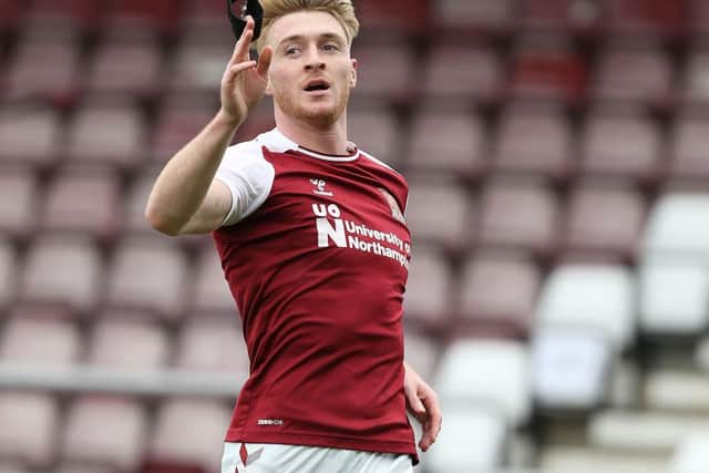 Ryan Watson raised his black armband to the sky after scoring for the Cobblers on Saturday. He was a former Town team-mate of Lee Collins