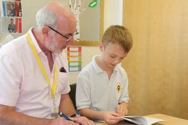 An East Hunsbury Primary School pupil reads with a Richmond Northampton resident