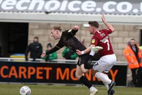 Sam Hoskins pulls back Mansfield's Harry Charsley to concede a penalty in the 10th minute of the Cobblers' 2-1 defeat at the PTS Academy Stadium. The Town man was sent off for the challenge (Picture: Pete Norton)