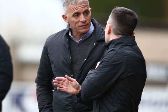 Keith Curle talks to the fourth official during Saturday's game.