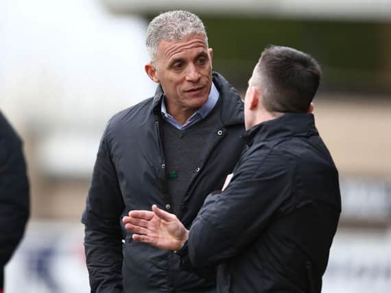 Keith Curle talks to the fourth official during Saturday's game.