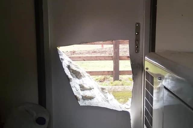 The hole in the door left by the intruders at Cobblers Car Wash