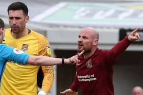 Alan McCormack takes issue with Peter Wright's decision to award Mansfield a penalty and send off Sam Hoskins