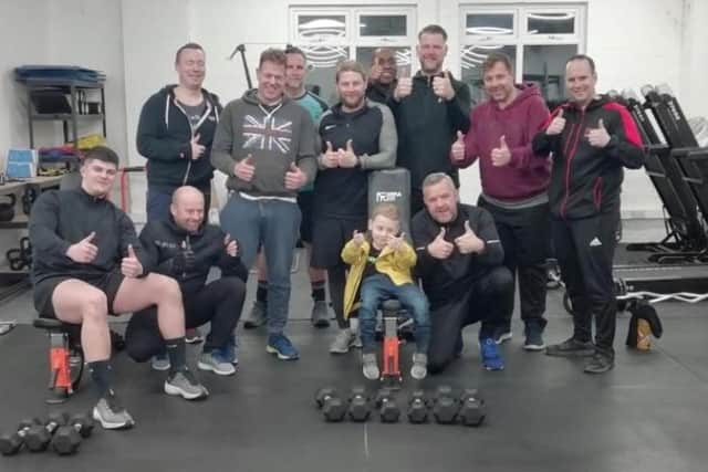 Harry pictured with some of the Wolf Run team, who are raising money for him, at the gym.