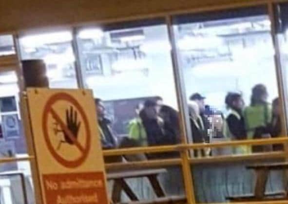 Workers bunch up together to start a shift at Primark