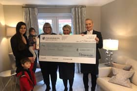 Persimmon Homes sales advisors Jo Warren and Martyna Wrangler present Community Champions funding to representatives of Tiny Tows pre-school in Towcester