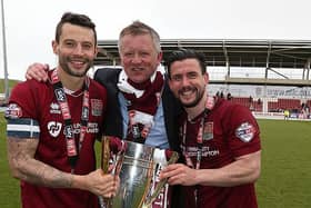 Chris Wilder poses alongside his two captains with the League Two trophy.