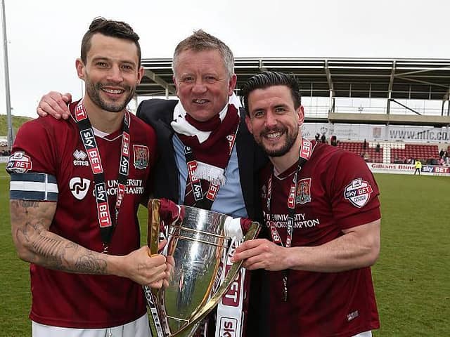 Chris Wilder poses alongside his two captains with the League Two trophy.