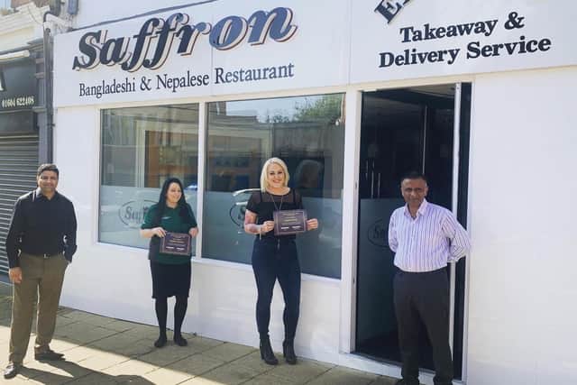The winners of the competition being presented with a certificate.