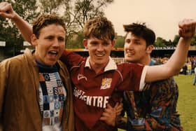 Cobblers goal hero Pat Gavin celebrates with two quick-off-the-mark pitch invaders at Gay Meadow
