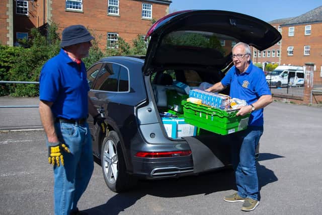 Tim Bedward (left) and Brain May (right) from the rotary club volunteered their time to shop for and then deliver the goods. Photo: Kirsty Edmonds.