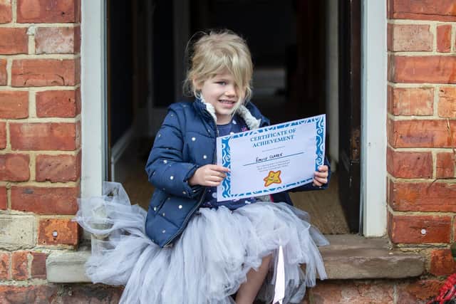 Emily pictured with her certificate after running the race.