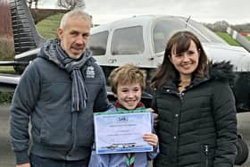 Leo Gleadell with his mother and father after he was treated to a flight from Turweston airfield in Brackley as a reward for what he did.