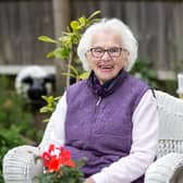 Former wartime evacuee, Beryl Harper is pictured in her garden by Kirsty Edmonds.