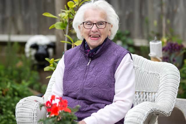 Former wartime evacuee, Beryl Harper is pictured in her garden by Kirsty Edmonds.