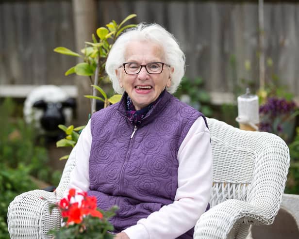 Former wartime evacuee, Beryl Harper is pictured in her garden by Kirsty Edmonds.