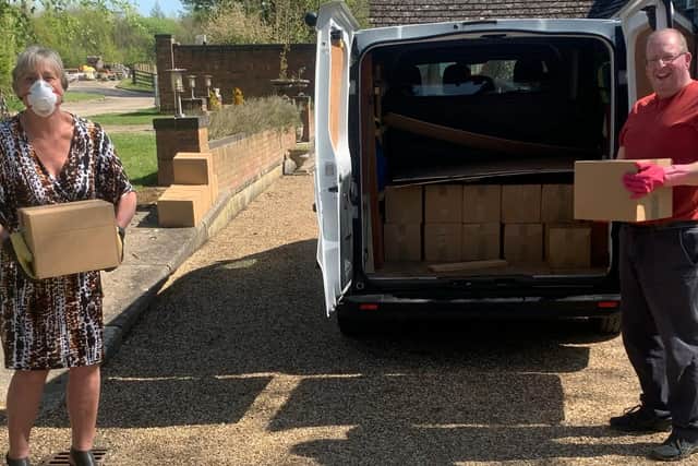 Northamptonshire Community Larders founder Miranda Wixon and Martyn Dearsley of SNVB unload boxes