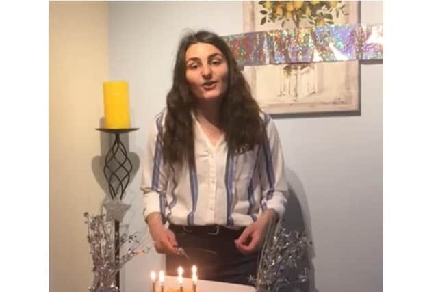 Northampton High School head girl Daria cuts the cake on a livestream from her house for the school's birthday.
