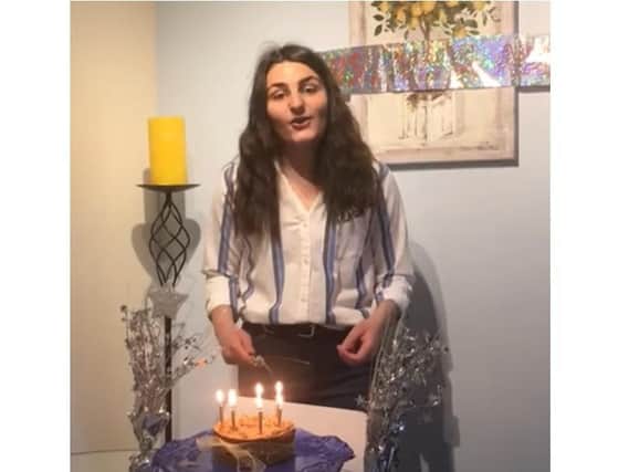 Northampton High School head girl Daria cuts the cake on a livestream from her house for the school's birthday.