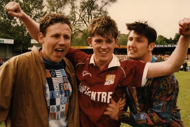 Pat Gavin celebrates with Cobblers supporters on the Gay Meadow pitch